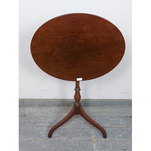 733 - A 19th century oval mahogany tilt-top wine table, on a faux bamboo turned column with delicate tripo... 