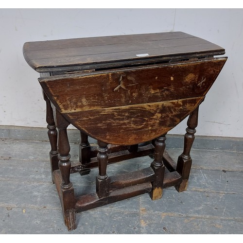 759 - An 18th century oak gate-leg table of small proportions, on turned and block supports with hoof feet... 