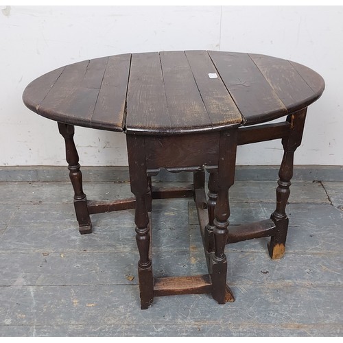 759 - An 18th century oak gate-leg table of small proportions, on turned and block supports with hoof feet... 