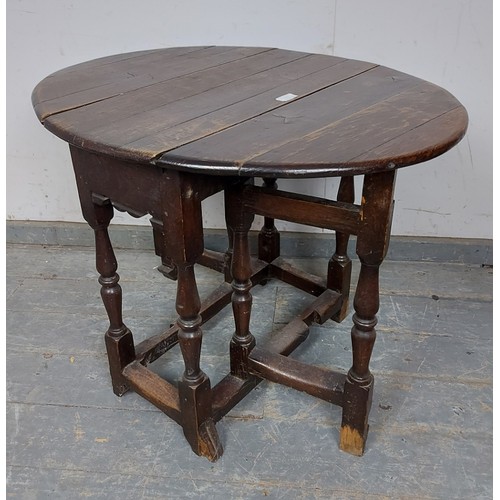 759 - An 18th century oak gate-leg table of small proportions, on turned and block supports with hoof feet... 