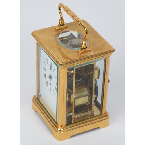 11 - A French gilt brass striking carriage clock, 20th century. With enamelled white dial and black Roman... 