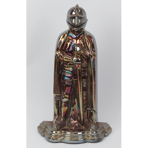 13 - A lustre glazed cast iron fireside companion set modelled as a knight in armour, early 20th century.... 