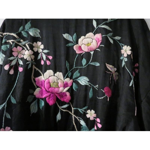 140 - A Chinese silk embroidered black robe, circa 1920s/30s. 137 cm length.
Condition report: Some age re... 