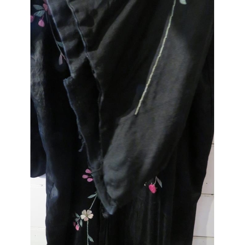 140 - A Chinese silk embroidered black robe, circa 1920s/30s. 137 cm length.
Condition report: Some age re... 