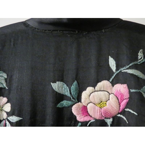 140 - A Chinese silk embroidered black robe, circa 1920s/30s. 137 cm length.
Condition report: Some age re... 