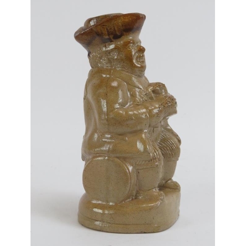 165 - A salt glazed stoneware figural flask, 19th century. Depicting a portly gentleman seated on a barrel... 