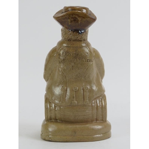 165 - A salt glazed stoneware figural flask, 19th century. Depicting a portly gentleman seated on a barrel... 