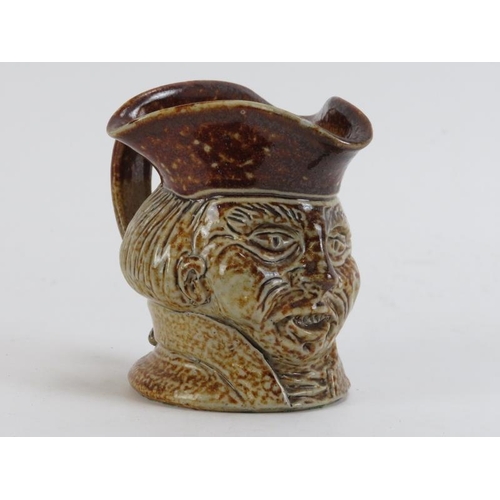 171 - A tiger glazed stoneware character jug, 18th/19th century. Depicting a male head with tricorn hat. 1... 