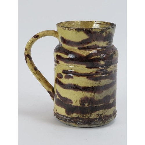 180 - Kitchenalia: A French treacle glazed cream earthenware jug, 19th century. Typically used for heating... 