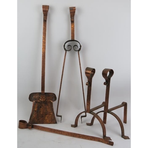 198 - A set of Arts and Crafts fireplace implements, late 19th century. Comprising a pair of fire dogs, co... 