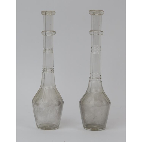 20 - Two late Georgian / Regency period clear glass toddy lifters. With knopped stems and faceted decorat... 