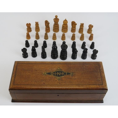 26 - A turned boxwood and ebony chess set, late 19th/early 20th century. Housed in an oak box. (25 items)... 