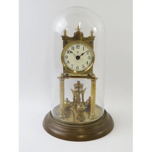 284 - A brass 400 Day Anniversary clock with enamel dial under glass dome. Overall height 31cm.
Condition ... 