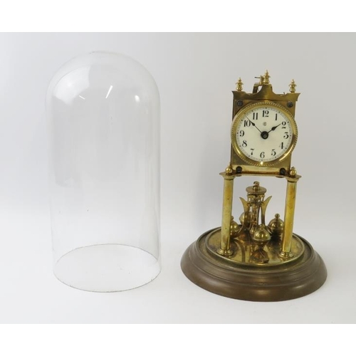 284 - A brass 400 Day Anniversary clock with enamel dial under glass dome. Overall height 31cm.
Condition ... 