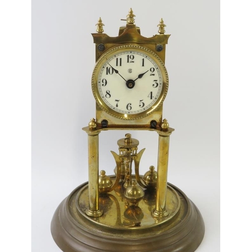 284 - A brass 400 Day Anniversary clock with enamel dial under glass dome. Overall height 31cm.
Condition ... 