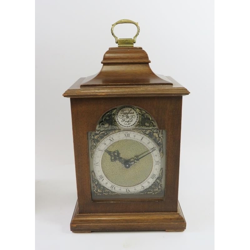 293 - A turn of the century continental mantel clock with carved wood case and a late 20th century Georgia... 