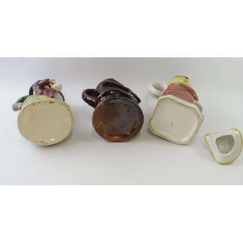 299 - Three large pottery Toby jugs, including a treacle glaze snuff taker and two hand decorated examples... 