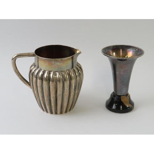 385 - A 19th century Swedish silver cream jug of fluted design, marked for 1893, and a white metal trumpet... 