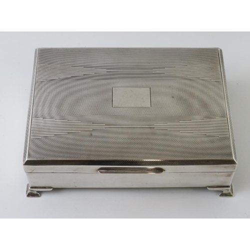 388 - A 1930s Art Deco silver cigarette box with cedar wood lining and weighted base. 17cm x 12cm. Approx ... 