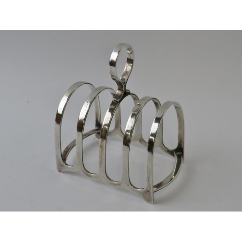 393 - A 1930s silver four slice toast rack with loop handle.  Hallmarked for Sheffield 1931, maker Cooper ... 