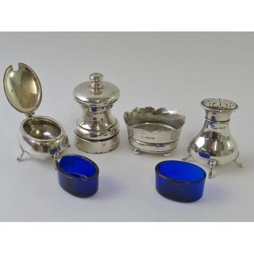 395 - Four mixed silver cruets including a pepper grinder, pepperette, mustard pot and salt.  All fully ha... 