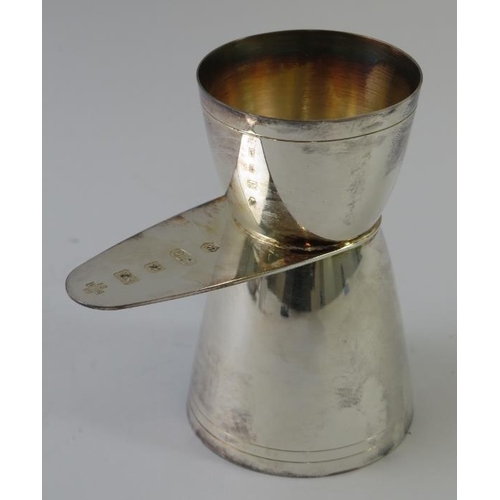 403 - A silver cocktail spirit jigger bearing millennium hallmarks, a silver mounted match striker, a smal... 