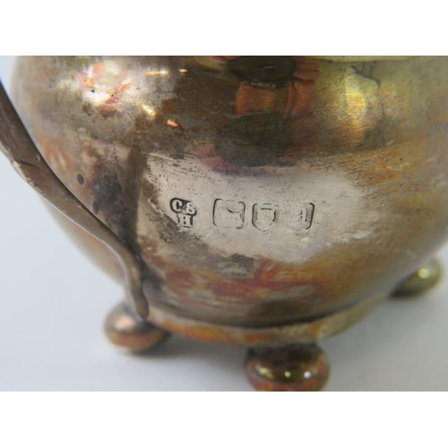 414 - A late 19th century Georgian revival silver cream jug with gadrooned rim and ball feet. Hallmarked f... 