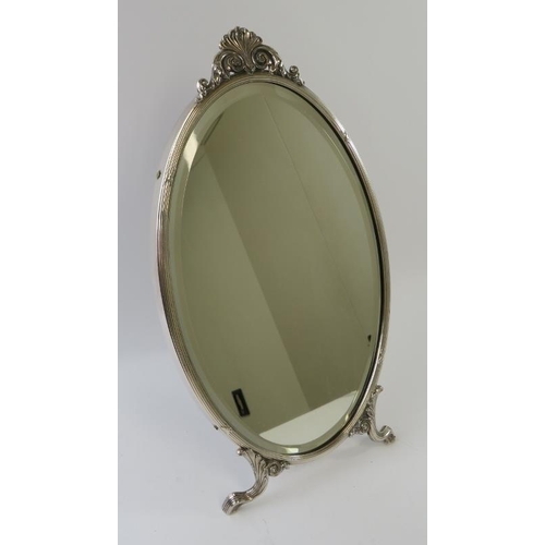 420 - A fine WMF silver plated easel mirror of oval form with scrollate feet and finial and bevelled glass... 