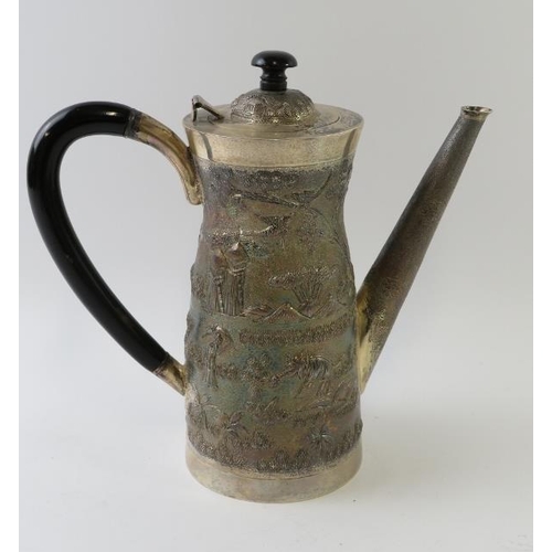 421 - A Far Eastern white metal coffee pot with embossed village scene decoration and ebonised handle and ... 