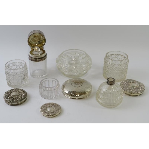 423 - Five antique silver topped cut glass vanity jars of various form and a silver collared perfume bottl... 