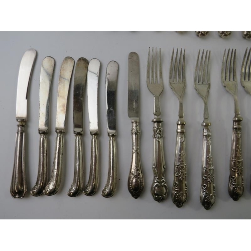 425 - A quantity of antique silver handled cutlery of various patterns and age.  Bearing English hallmarks... 