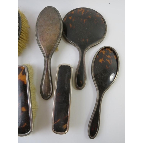 431 - A five piece silver and tortoiseshell backed vanity set including mirror and four brushes, and three... 