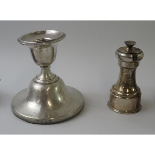 434 - Mixed hallmarked silver items to include a pepper grinder, tea strainer and stand, and candlestick. ... 