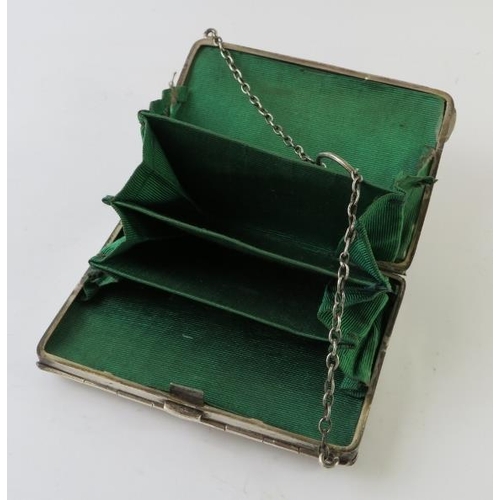 435 - An early 20th century silver combination purse and card case with interior green satin dividers, hal... 