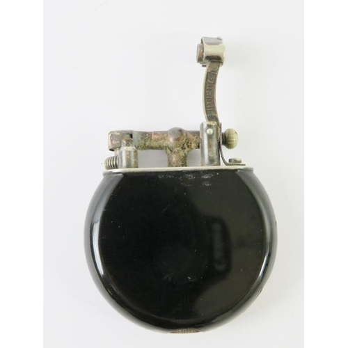 441 - A very rare black enamelled Dunhill swing arm cigarette lighter, probably by Namaki. Black circular ... 