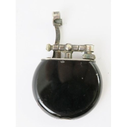 441 - A very rare black enamelled Dunhill swing arm cigarette lighter, probably by Namaki. Black circular ... 