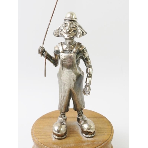 An Amusing Silver Clown Figure With Kite, Mounted On An Oak Plinth, By 