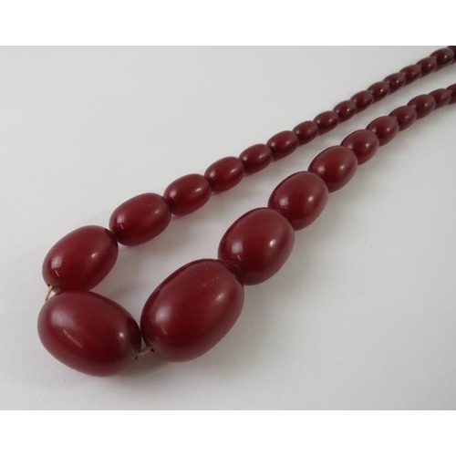 452 - A graduated strand of vintage cherry amber beads, 9.8mm -25mm, 450mm long, 33 grams all measurements... 