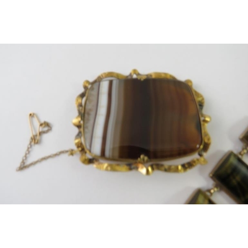 469 - A precious yellow metal and tiger’s eye and panel bracelet stamped 9CT; and a large banded agate pin... 