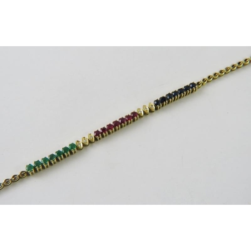 487 - A pretty tennis style bracelet with panels of emeralds, rubies and sapphires inter set with diamonds... 