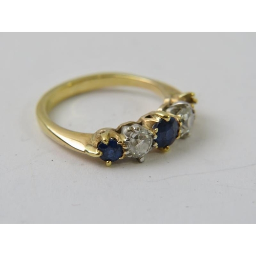 491 - A precious yellow metal sapphire and diamond half-hoop ring, with two round old cut diamonds and two... 