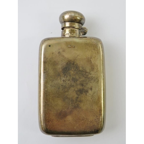 493 - An early 20th century silver hip flask of plain form, hallmarks rubbed, height 12cm. Approx gross we... 