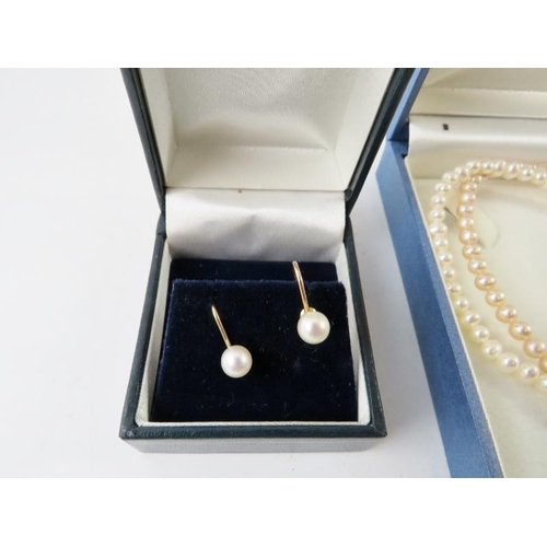 498 - A two strand freshwater pearl necklace; and other faux pearl necklaces and a pair of screw back earr... 