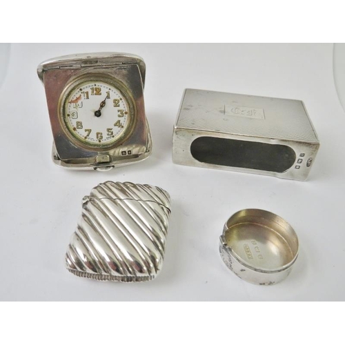 499 - A mixed lot of silver collectables including a folding travel clock (a/f), matchbox case, vesta, pil... 