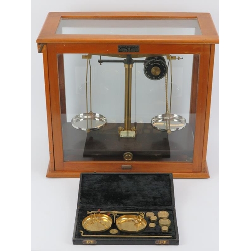 56 - A Griffin Tatlock Ltd pair of vintage laboratory balance scales and a boxed set of brass scales. The... 