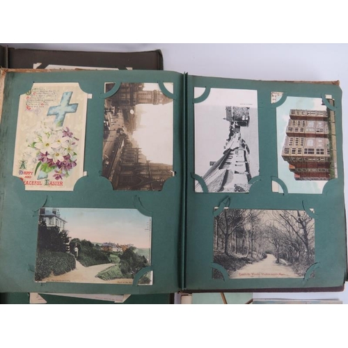 91 - A collection of postcards and scrap book cuttings, early 20th century. Four albums containing postca... 