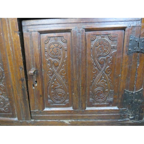 705 - A 17th century oak court cupboard of small proportions, having inverted finials above three cupboard... 