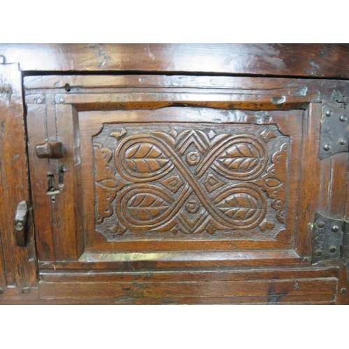 705 - A 17th century oak court cupboard of small proportions, having inverted finials above three cupboard... 