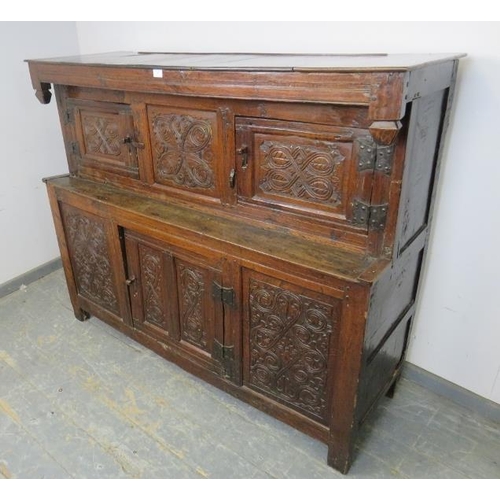 705 - A 17th century oak court cupboard of small proportions, having inverted finials above three cupboard... 