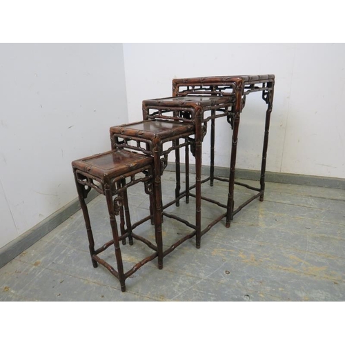 710 - A set of four antique Chinese hardwood nesting tables, having carved and pierced frieze modelled as ... 